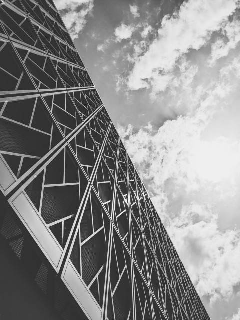 a tall tower with clouds in the background