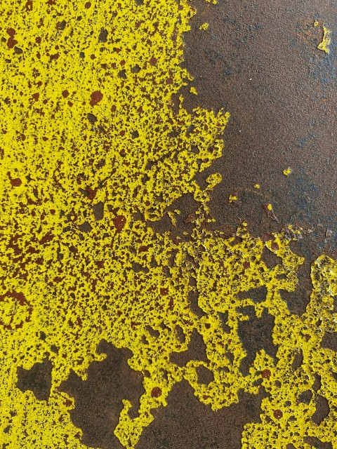 a close up of yellow paint on the ground