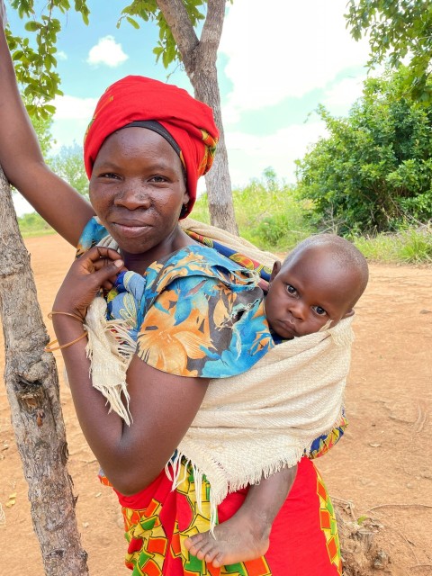 a woman holding a baby in her arms