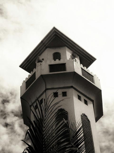 a tall tower with a clock on the top of it