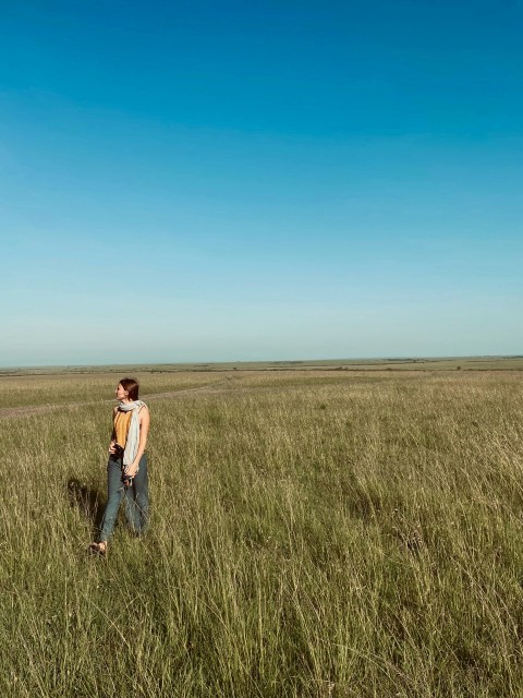 a man standing in a field of tall grass