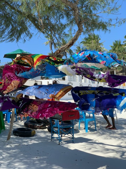 a bunch of colorful umbrellas hanging from a tree