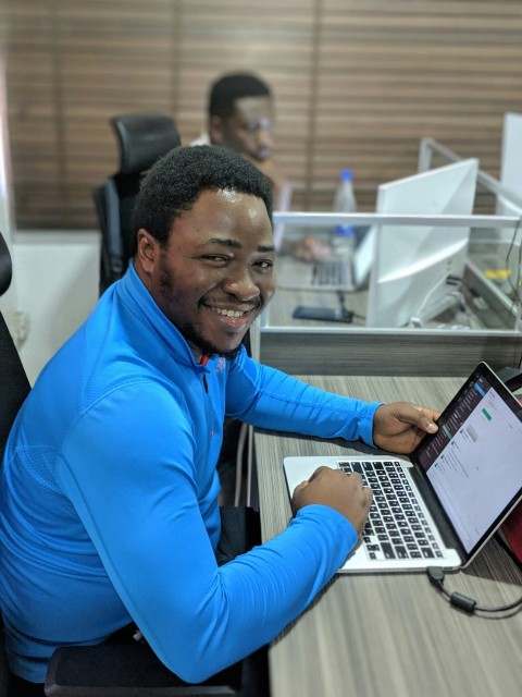 smiling man using laptop computer wT