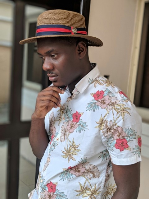 man wearing hat and floral t shirt