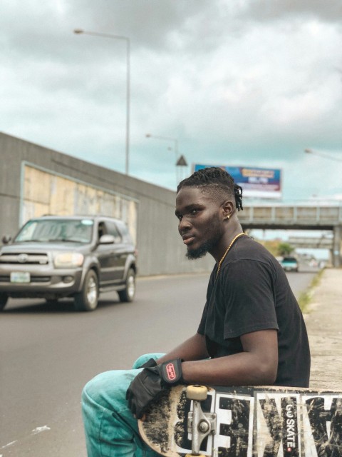 a man sitting on a skateboard