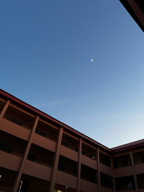 a building with a moon in the sky MA7iKoOc