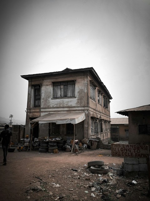 a person standing next to a house