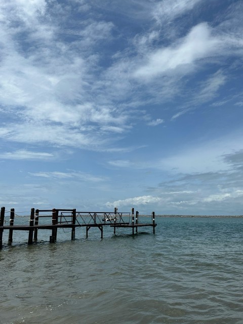 a pier in the middle of a body of water