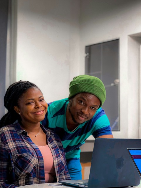 a man and a woman are looking at a laptop P6