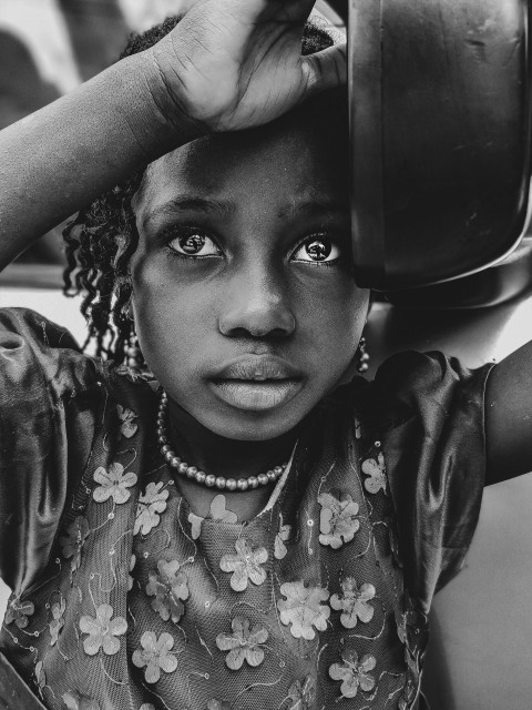 girl holding bowl on grayscale photography