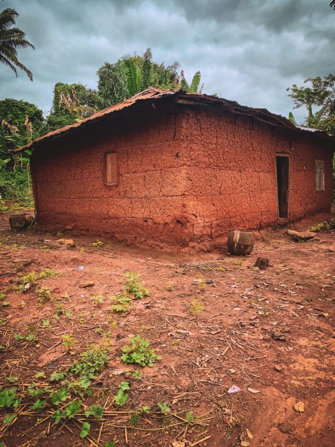 a brick building with a dirt yard