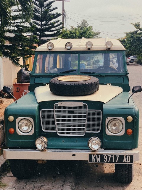 classic green suv on park during daytime