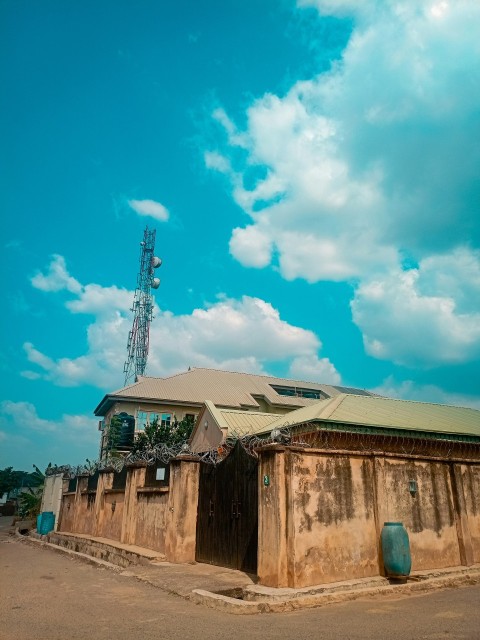 a building with a cell phone tower in the background