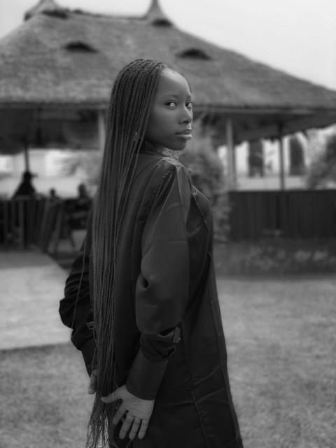 a woman with long hair standing in front of a gazebo