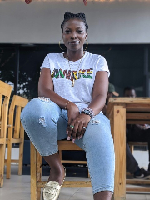 girl in white and blue crew neck t shirt and blue denim jeans sitting on brown