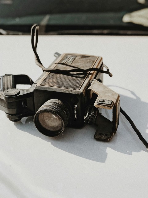 vintage black and gray panasonic camera on vehicle hood