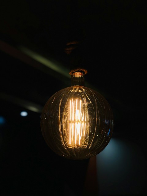 a light bulb hanging from the ceiling in a dark room
