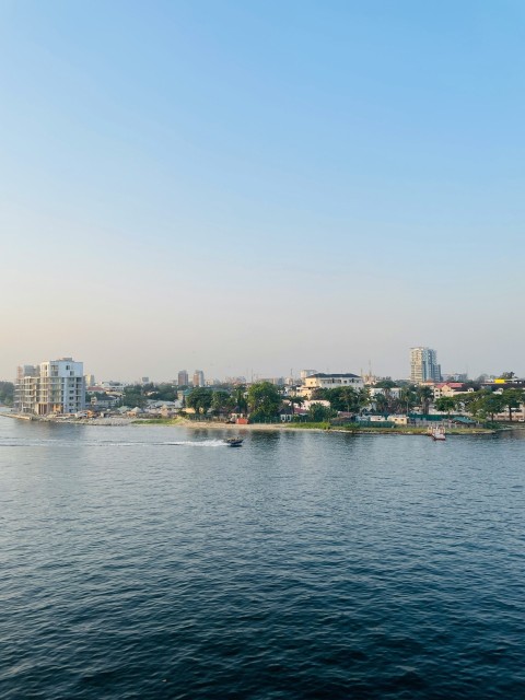 a large body of water with a city in the background