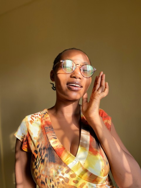 girl in yellow and red floral dress wearing eyeglasses g