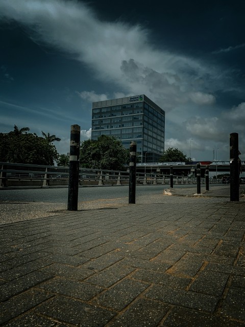 a city street with a tall building in the background