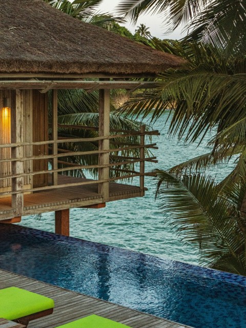 brown wooden gazebo on body of water during daytime g