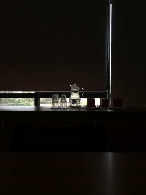 clear glass pitcher and drinking glasses set on brown table