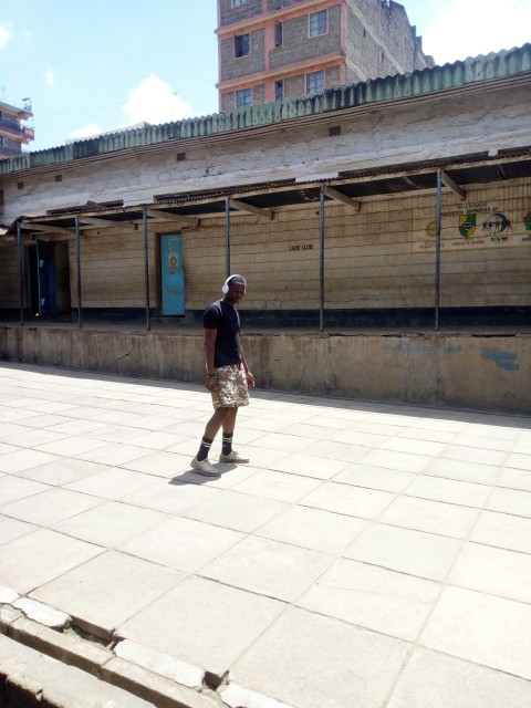 woman in brown dress standing on white floor tiles during daytime