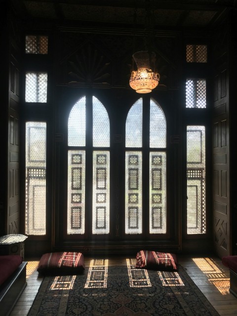 a large room with a lot of windows and a rug on the floor