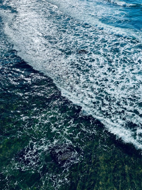 a person riding a surfboard on top of a body of water