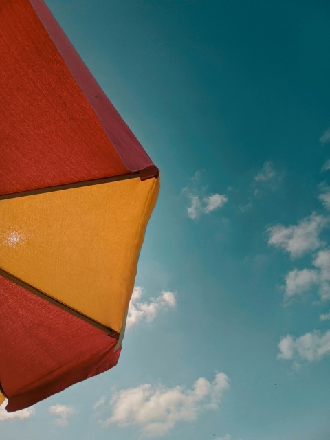 orange and yellow concrete building under blue sky during daytime