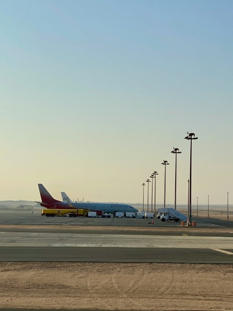 a large jetliner sitting on top of an airport tarmac a