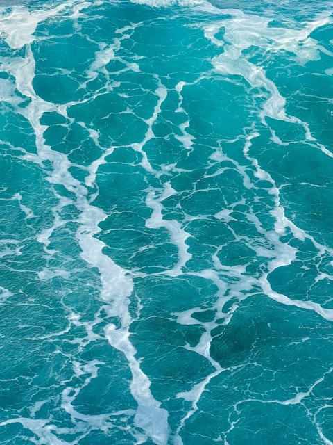 a person riding a surfboard on top of a wave in the ocean