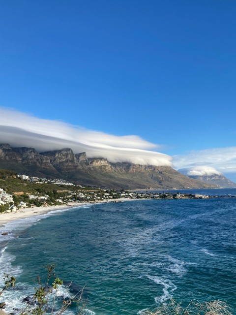 a large body of water with a mountain in the background