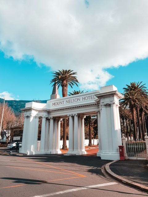 mount nelson hotel arch under cloudy sky