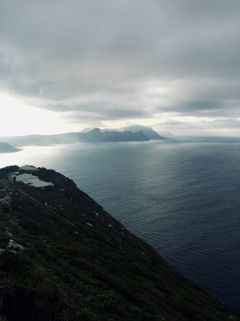 a view of a body of water with mountains in the background