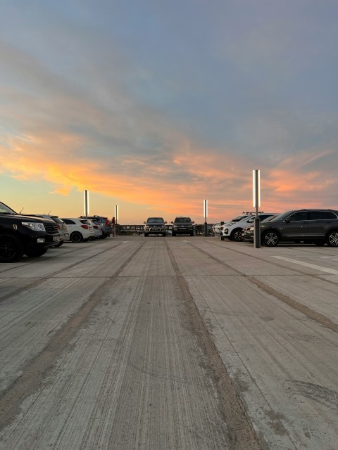 a parking lot filled with lots of parked cars Y