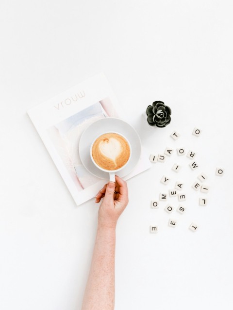 person holding coffee cup wItJ5AEO