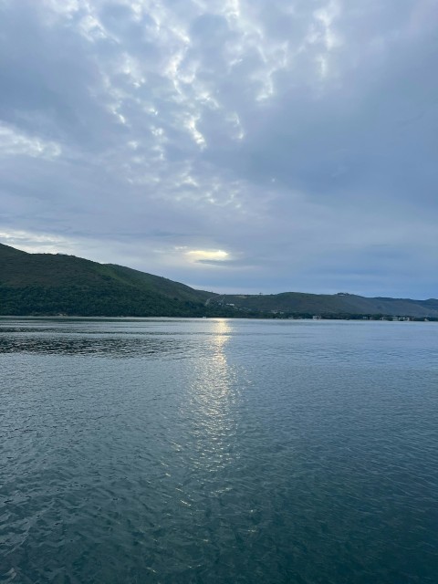 a large body of water sitting under a cloudy sky