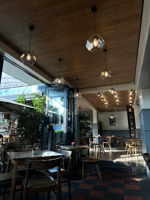 a restaurant with a checkered floor and wooden ceiling