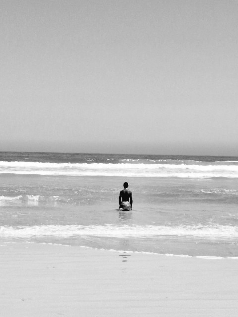 a man sitting on a surfboard in the ocean