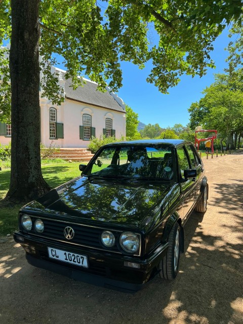 a black car parked on the side of a road