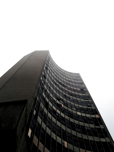 a very tall building with a clock on its side