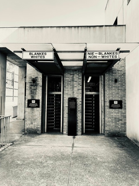 a black and white photo of a building with two doors