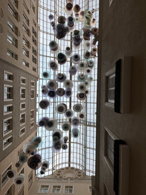 a very tall building with a bunch of glass balls hanging from its ceiling