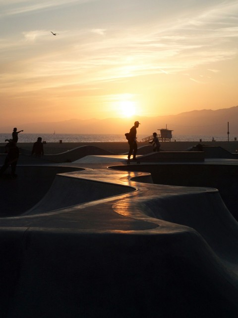 a group of people riding skateboards at a skate park