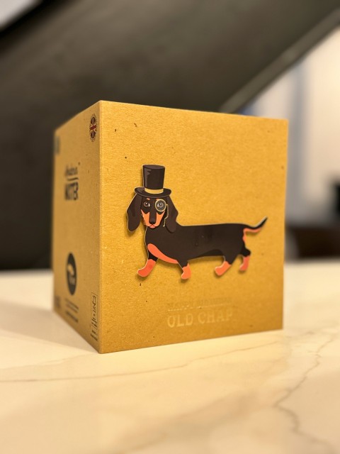 a cardboard box with a picture of a dog wearing a top hat