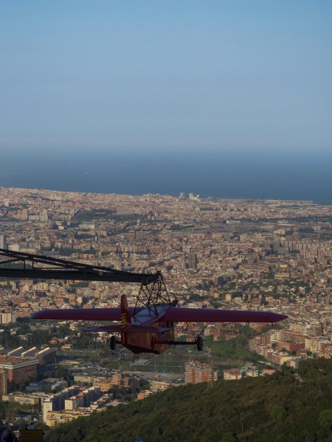 a small plane flying over a large city