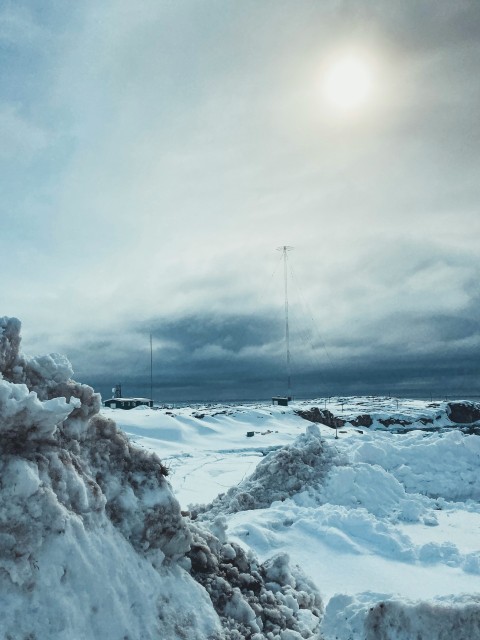 a large pile of snow sitting on the side of a road