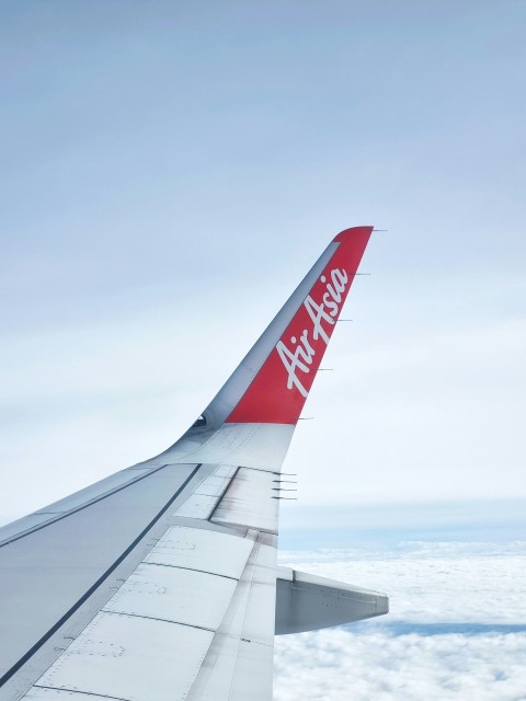 the wing of an airplane flying above the clouds