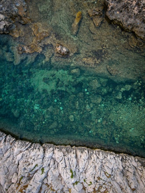 a large body of water surrounded by rocks k